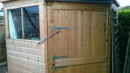 outside of the boys shed - stable door closed.webp